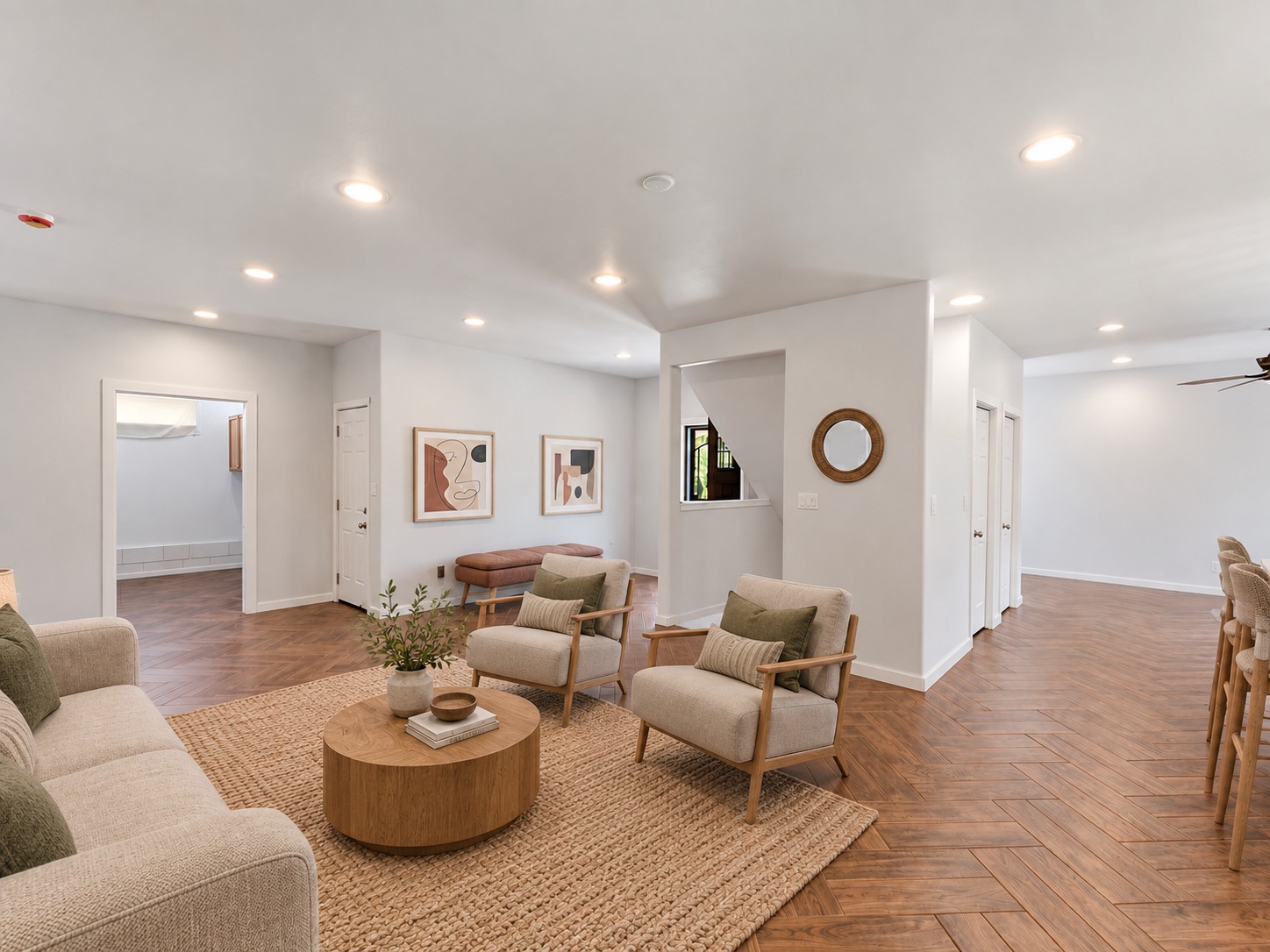 Living room seating area with hallway and stair views